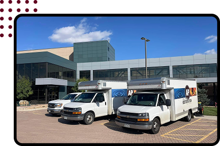 All Phase Restoration vans in front of building